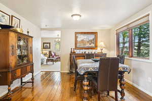 Dining space with hardwood / wood-style floors and baseboards