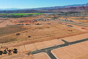 Aerial view of sparsely populated area featuring a mountain backdrop and a desert landscape