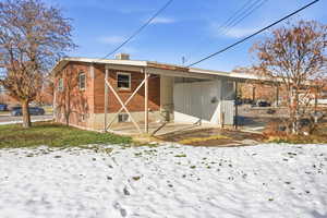 Snow covered property featuring a patio