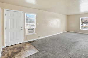 Spare room with baseboards and a textured ceiling