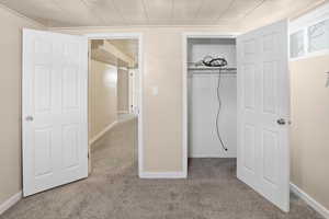 Unfurnished bedroom with carpet and a closet