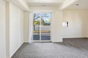 Carpeted empty room with baseboards