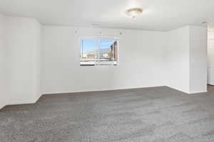 Carpeted empty room with baseboards
