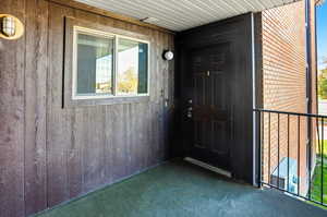 Doorway to property with brick siding