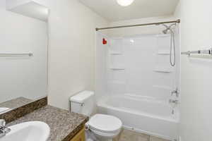 Full bath featuring vanity, shower / bath combination, and light tile patterned floors