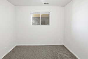 Carpeted empty room with baseboards