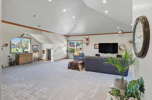 Living area with ornamental molding, carpet flooring, high vaulted ceiling, and recessed lighting