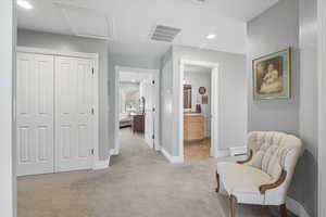 Sitting room with light carpet, attic access, recessed lighting, and a baseboard heating unit