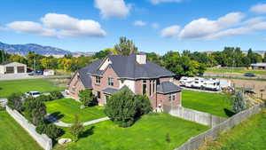 Aerial view of property and surrounding area with mountains