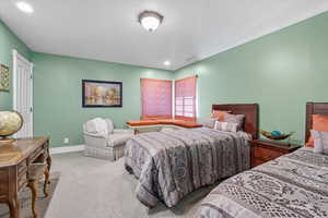 Carpeted bedroom with a textured ceiling and recessed lighting