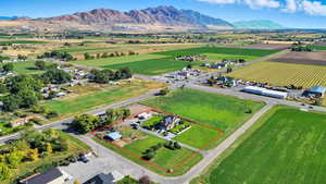 Aerial view of sparsely populated area with mountains, property parcel outlined, and abundant farmland