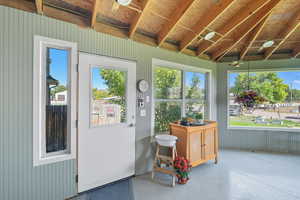 Sunroom / solarium featuring concrete flooring and healthy amount of natural light