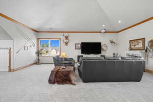 Living room with crown molding, light carpet, lofted ceiling, and recessed lighting