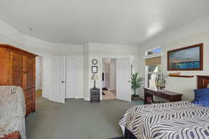 Carpeted bedroom with baseboards