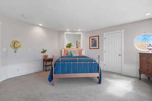 Carpeted bedroom featuring recessed lighting and baseboards