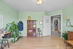 Sitting room with light wood finished floors and baseboards