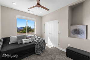 Living area with carpet floors, ceiling fan, recessed lighting, and a mountain view