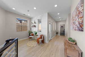 Corridor featuring light wood-style floors and recessed lighting