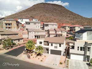 Aerial perspective of suburban area with a mountainous background