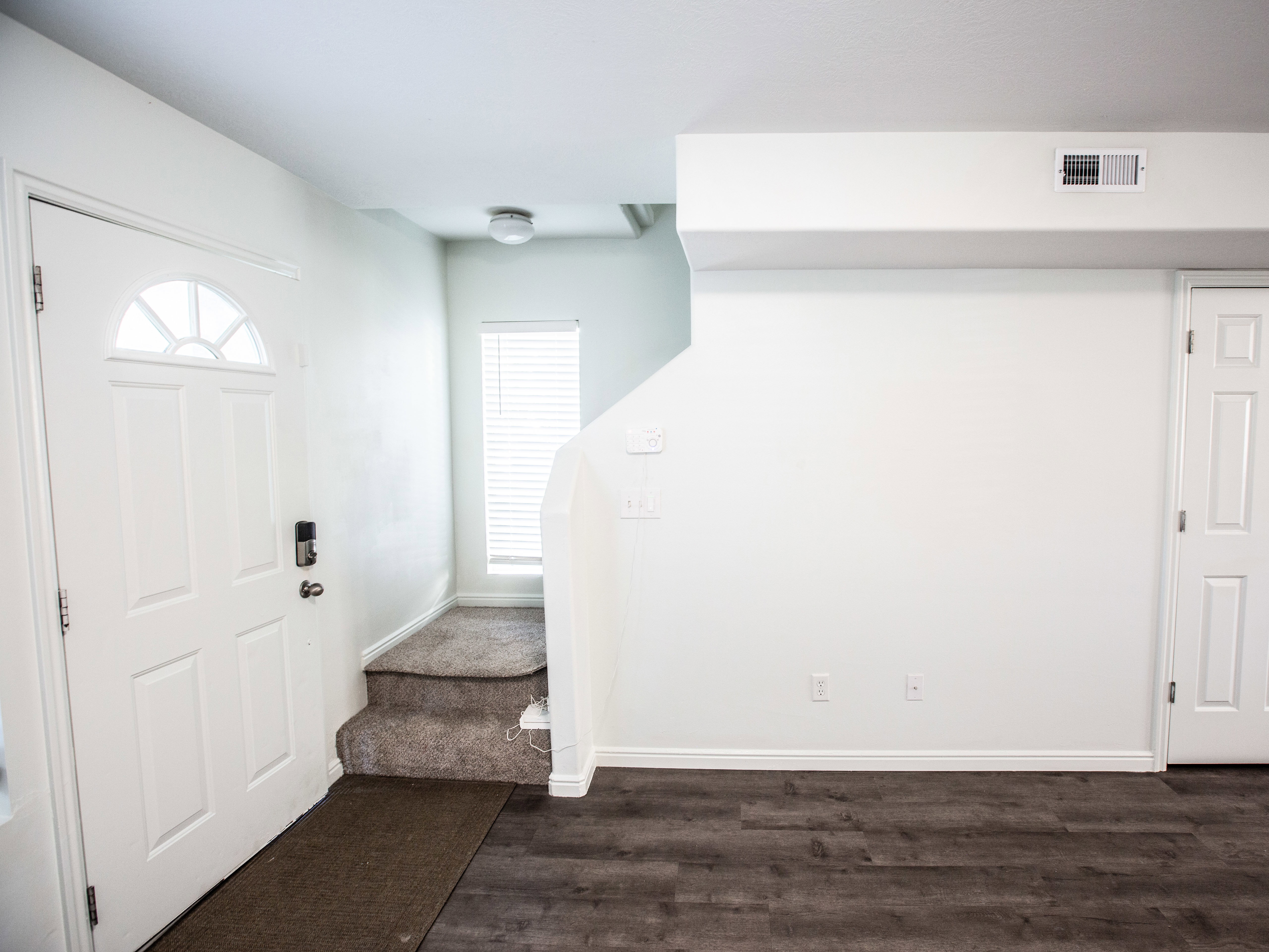 Foyer entrance featuring baseboards and dark wood finished floors
