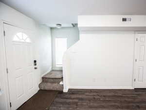 Foyer entrance featuring baseboards and dark wood finished floors