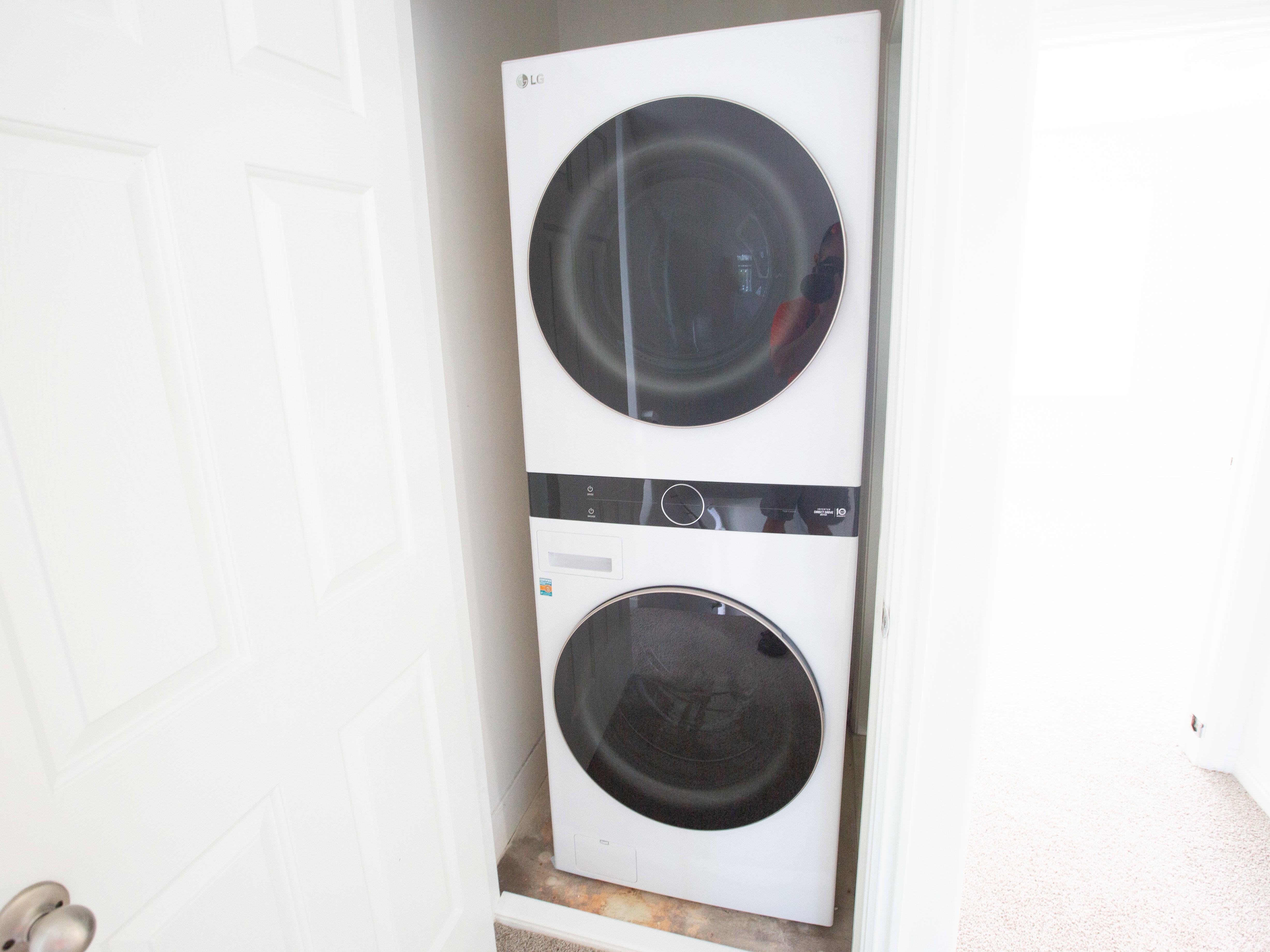 Washroom with stacked washing machine and dryer