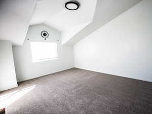 Bonus room with vaulted ceiling and carpet floors