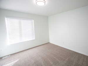Spare room with baseboards and carpet flooring