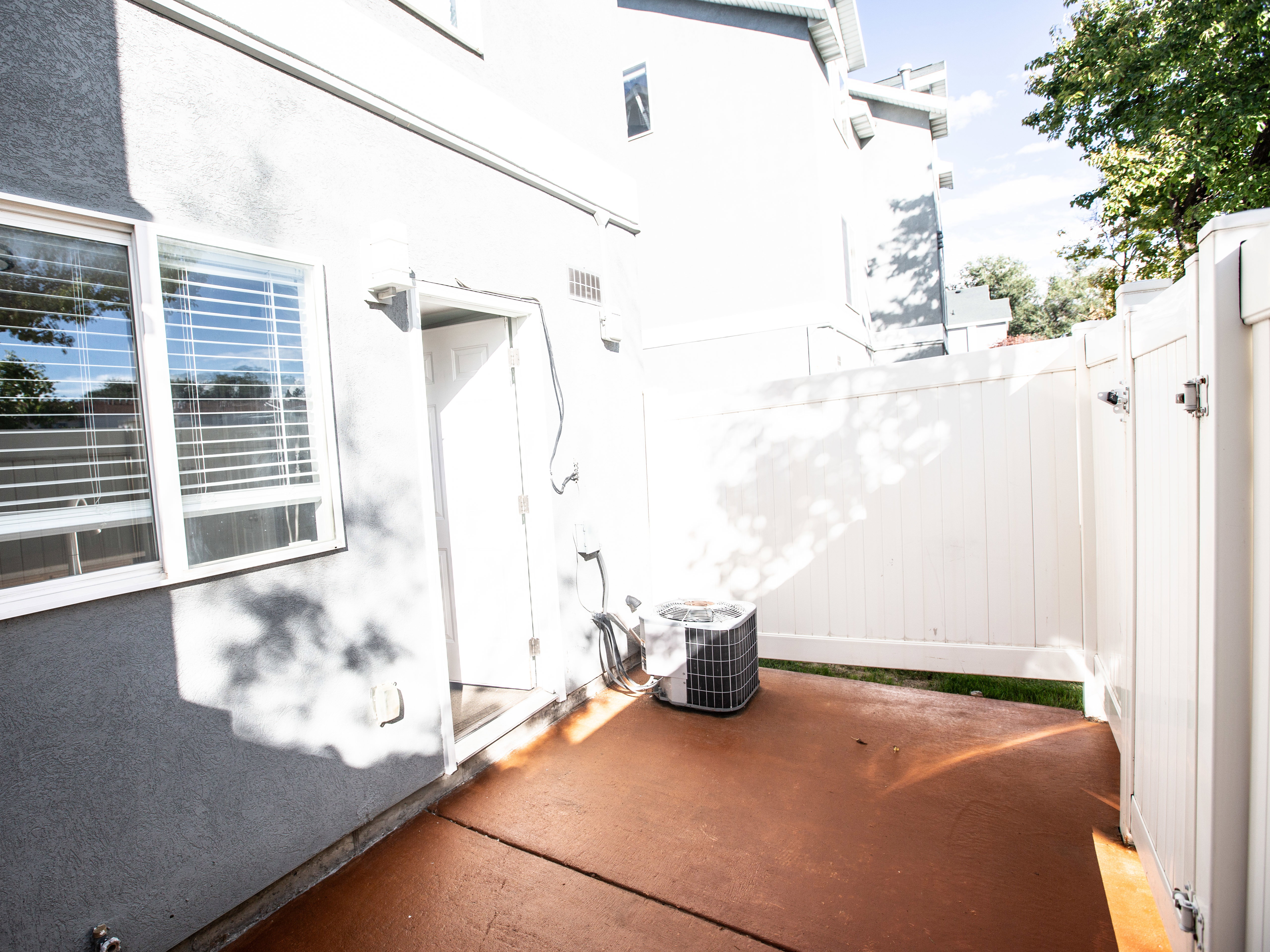 View of side of property with stucco siding and a patio