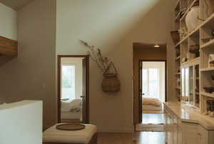 Interior space featuring light wood-style flooring and lofted ceiling