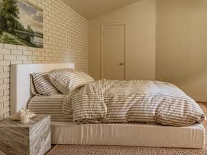 Bedroom with lofted ceiling