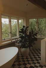Sunroom / solarium featuring plenty of natural light and beam ceiling