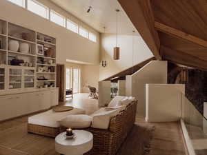 Sitting room featuring a high ceiling and wood finished floors