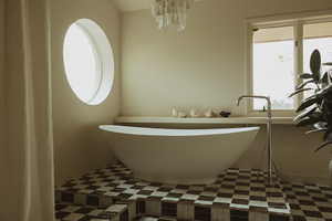 Full bath featuring a soaking tub