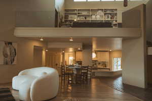 Living room with dark wood-style flooring and baseboards