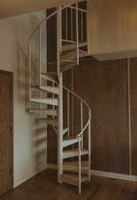Stairs featuring wood finished floors and baseboards