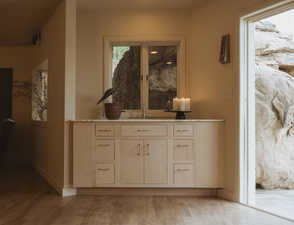 Hallway featuring light wood-style floors and baseboards