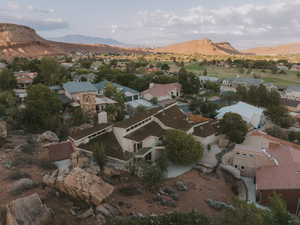 Aerial overview of property's location featuring nearby suburban area and a mountainous background