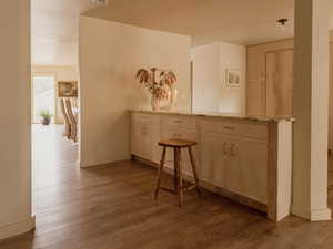 Corridor with light wood-style flooring and baseboards