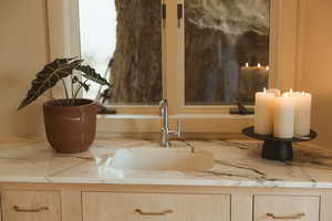 Kitchen view of light brown cabinets and light stone counters