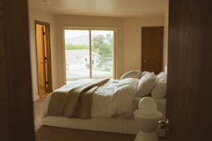 Bedroom featuring access to outside and wood finished floors