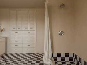 Full bathroom with a shower with curtain and tile patterned floors