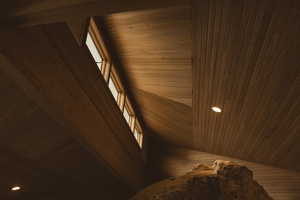 Detailed view of wooden ceiling, wood walls, and recessed lighting
