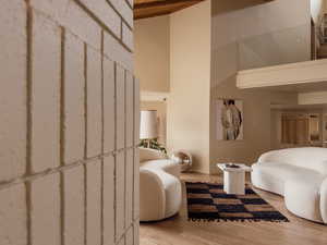 Bedroom with wood finished floors and a towering ceiling