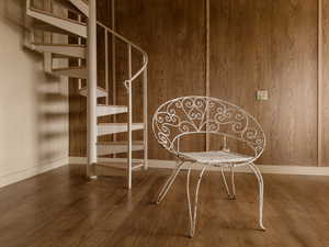 Interior space with wood finished floors, stairway, and wood walls