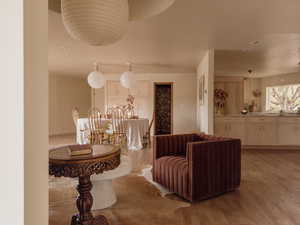 Living area with light wood-style floors and recessed lighting