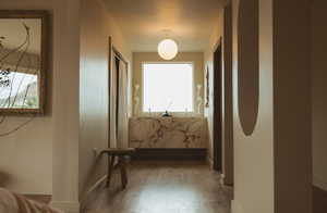 Hallway featuring wood finished floors and baseboards