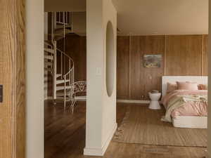 Bathroom featuring wood walls and wood finished floors