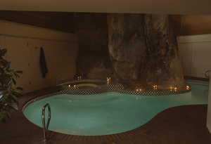 Pool at twilight with a pool with connected hot tub