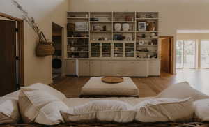 Living room with wood finished floors and washer / dryer